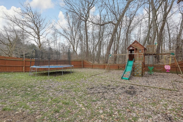 view of yard with a playground and a trampoline