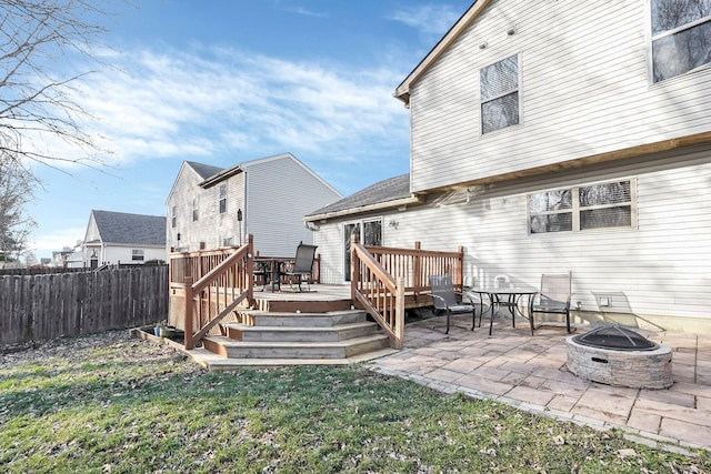 back of house featuring a wooden deck, a patio area, and an outdoor fire pit