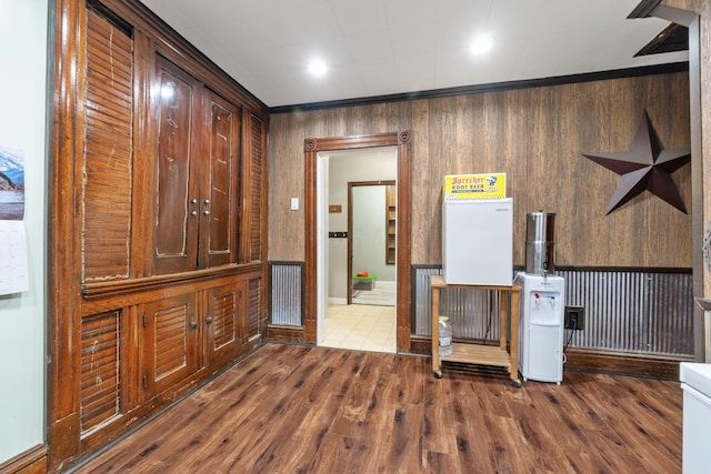 interior space with hardwood / wood-style flooring and wood walls