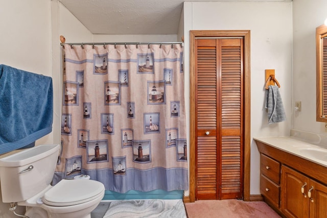 bathroom featuring vanity, toilet, and a textured ceiling