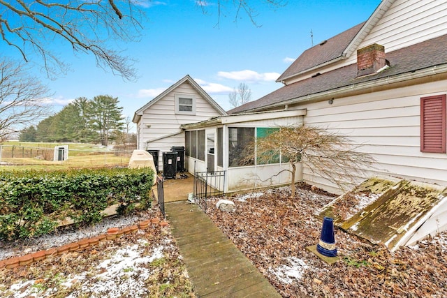 view of side of home featuring a sunroom