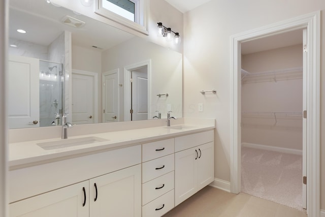 bathroom with vanity and a shower with door