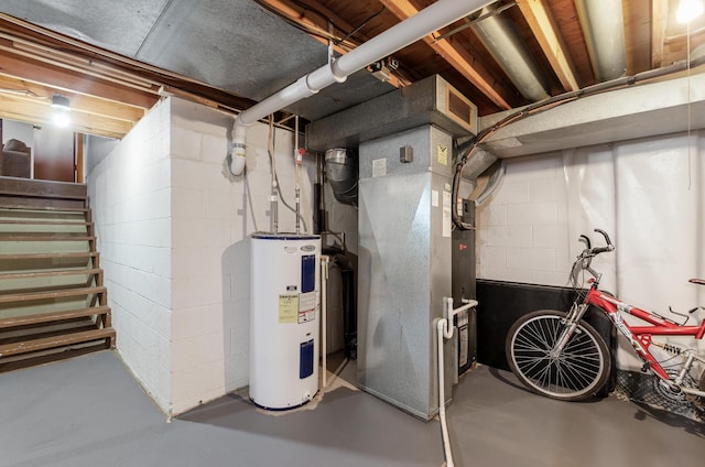 utilities featuring electric water heater, visible vents, and heating unit