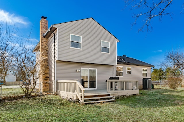 rear view of property with cooling unit, a lawn, a chimney, and fence