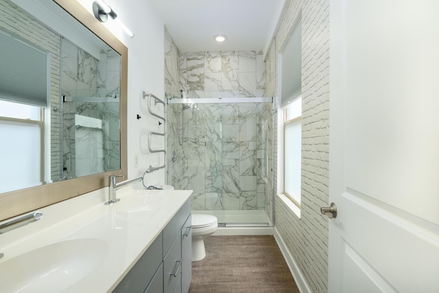 113 E Mithoff St, Columbus, OH 43206 - bathroom with a marble finish shower, double vanity, healthy amount of natural light, wood finished floors, and recessed lighting