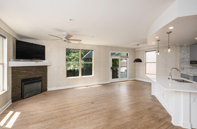113 E Mithoff St, Columbus, OH 43206 - unfurnished living room featuring a fireplace, a ceiling fan, light wood finished floors, and recessed lighting