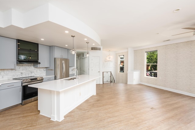 113 E Mithoff St, Columbus, OH 43206 - kitchen featuring appliances with stainless steel finishes, gray cabinetry, light countertops, decorative backsplash, and recessed lighting