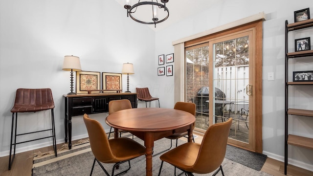 dining room with an inviting chandelier and hardwood / wood-style flooring