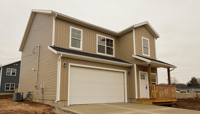 view of front of house with a garage and central air condition unit