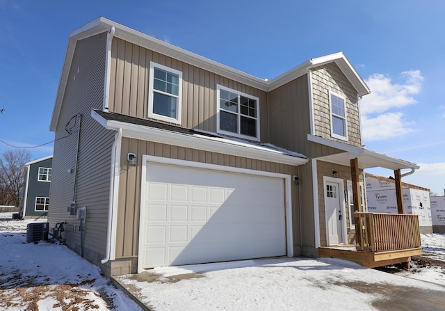 view of front of home featuring a garage and central air condition unit