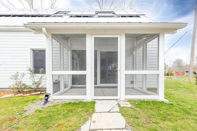 260 King St, Yellow Springs, OH 45387 - doorway to property with metal roof, a standing seam roof, solar panels, and a yard