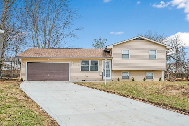 tri-level home with a garage and a front lawn