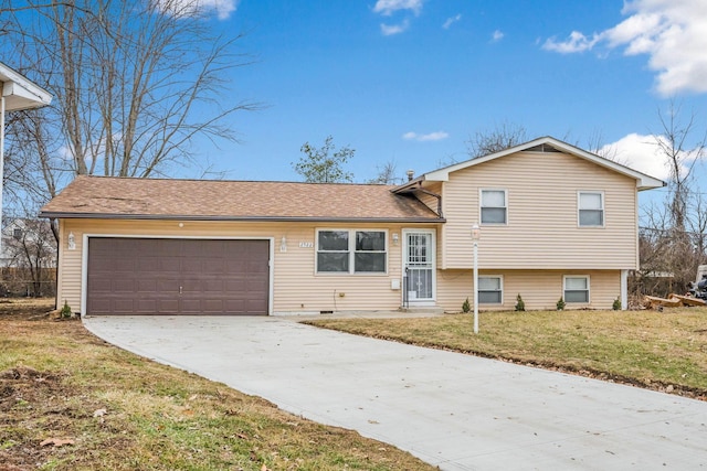 split level home with a garage and a front yard