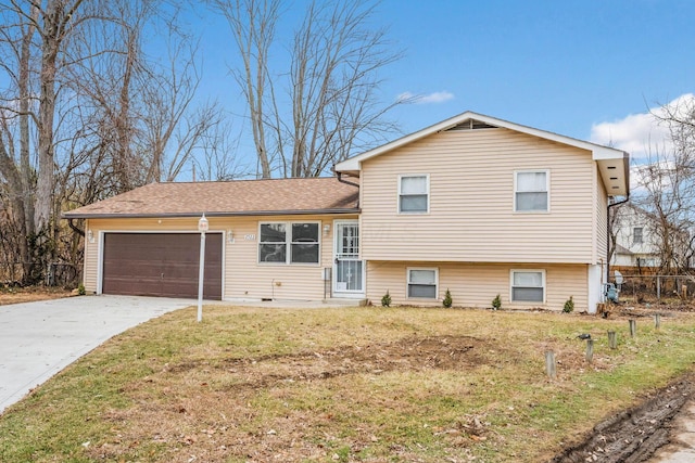 split level home featuring a garage and a front lawn