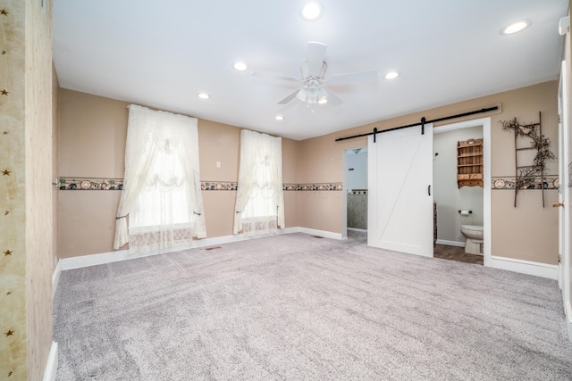 unfurnished room with carpet, baseboards, recessed lighting, a barn door, and ceiling fan