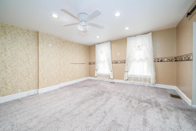 carpeted empty room featuring a ceiling fan, baseboards, and recessed lighting