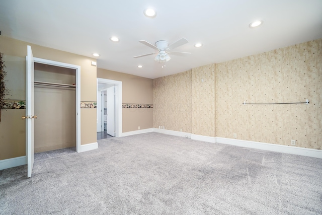 unfurnished bedroom with carpet flooring, baseboards, a closet, and recessed lighting