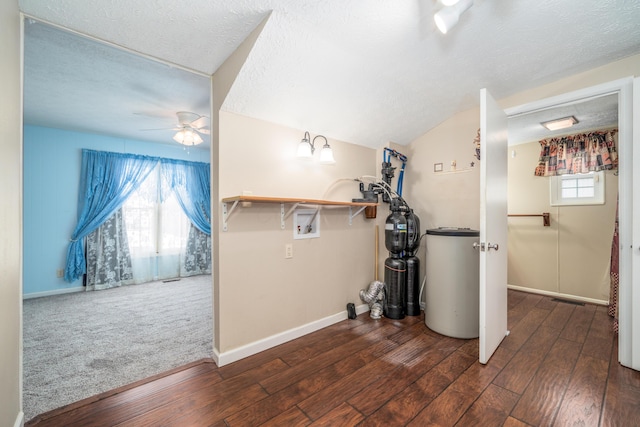 below grade area featuring baseboards, ceiling fan, dark wood-style floors, and a textured ceiling