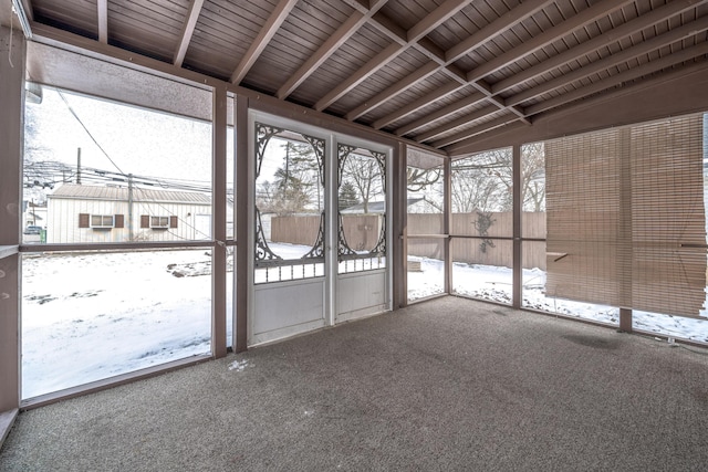 unfurnished sunroom featuring wooden ceiling and lofted ceiling with beams