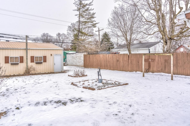 yard covered in snow with fence