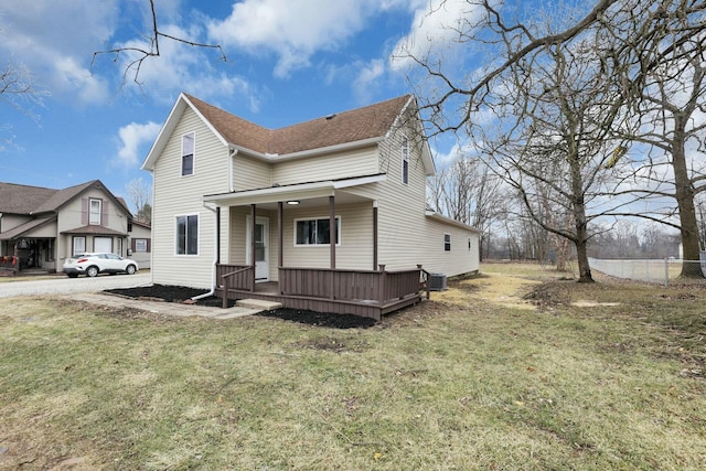 view of front of home with a front yard and cooling unit