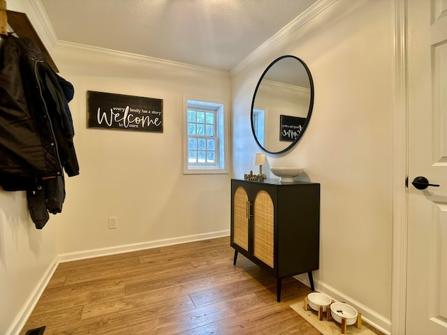 interior space featuring crown molding and light hardwood / wood-style floors