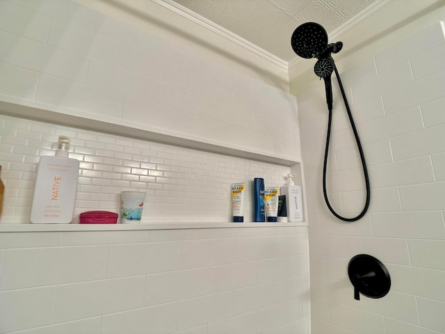 interior details featuring a tile shower and ornamental molding