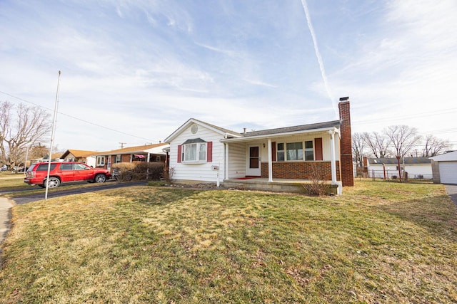 view of front of house with covered porch and a front lawn