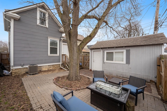 view of patio with central AC and a fire pit