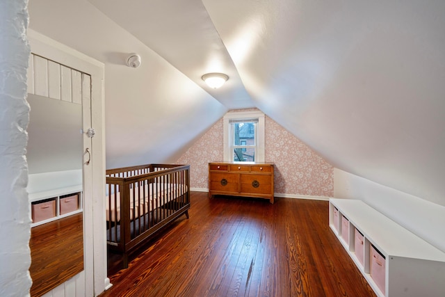 bedroom with lofted ceiling and dark hardwood / wood-style flooring