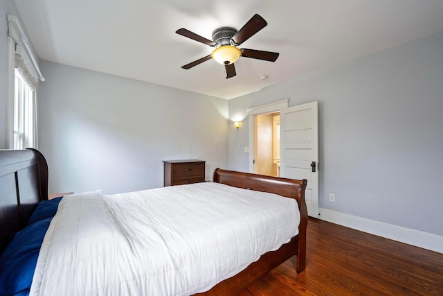 bedroom with dark hardwood / wood-style flooring and ceiling fan