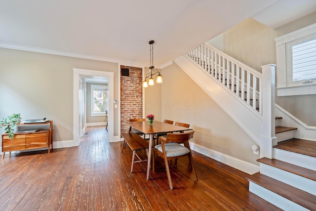 dining room with dark wood-type flooring and ornamental molding