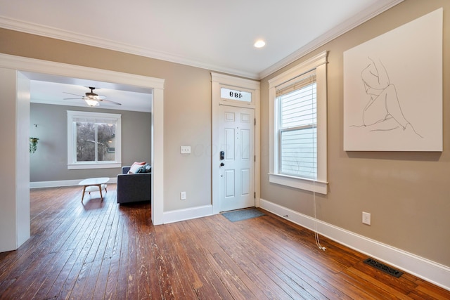 entrance foyer featuring crown molding, ceiling fan, and dark hardwood / wood-style floors