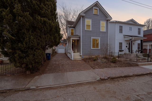 view of front of property with a garage and an outdoor structure