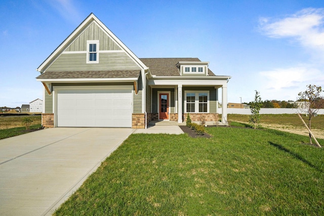 craftsman inspired home featuring board and batten siding, stone siding, driveway, and a front lawn