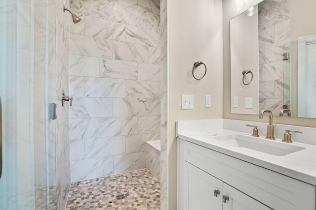 bathroom with a stall shower and vanity