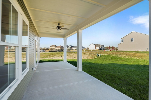 view of patio / terrace with a ceiling fan and a residential view