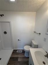 bathroom with vanity, wood-type flooring, and toilet