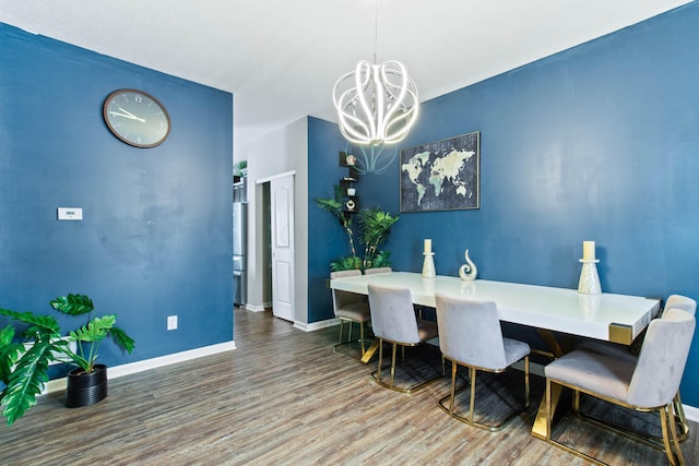 dining space featuring a notable chandelier and hardwood / wood-style flooring