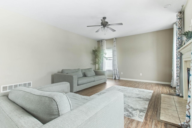 living room featuring hardwood / wood-style floors and ceiling fan