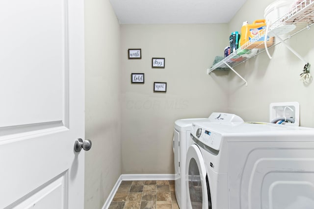 clothes washing area featuring washer and clothes dryer