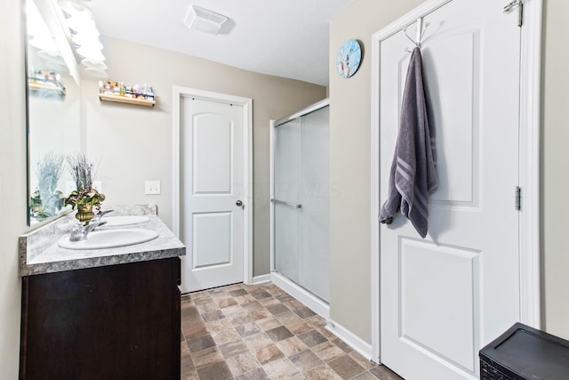 bathroom with vanity and a shower with shower door