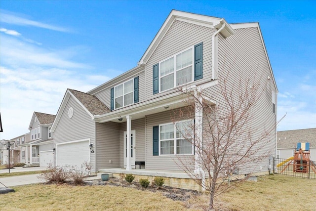 view of front of house featuring a garage, a porch, a front lawn, and a playground