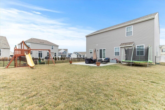 back of house with a patio, a playground, a trampoline, and a lawn