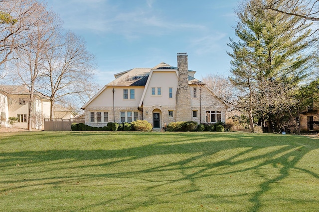 rear view of property with a yard