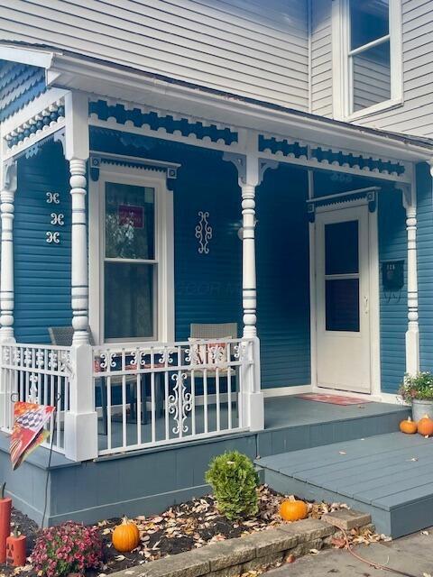 view of exterior entry with covered porch