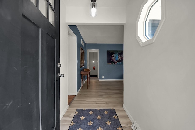 hallway with light hardwood / wood-style flooring