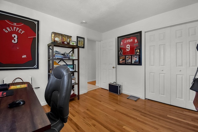 office space featuring wood-type flooring and a textured ceiling