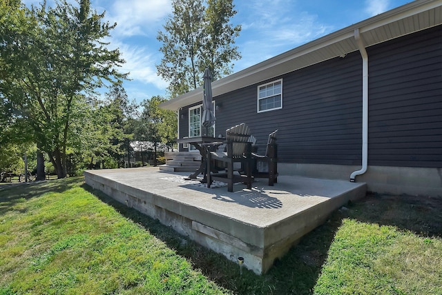 wooden terrace with a lawn