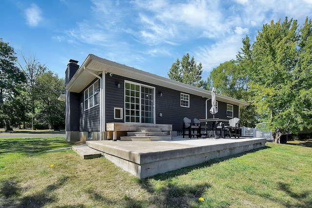 back of house featuring a yard and a patio